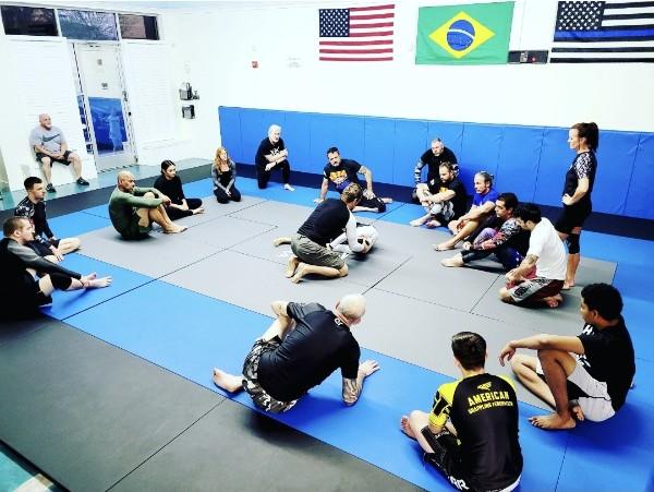 A small class gathered on the mat for instruction