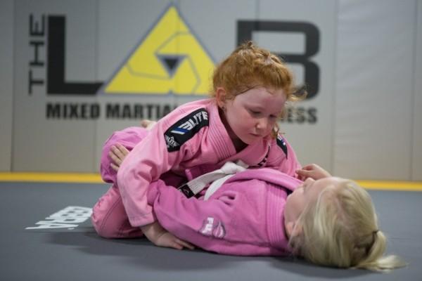 Two children practicing Brazilian Jiu Jitsu