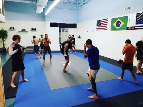 Students training in pairs with room to move on the mat